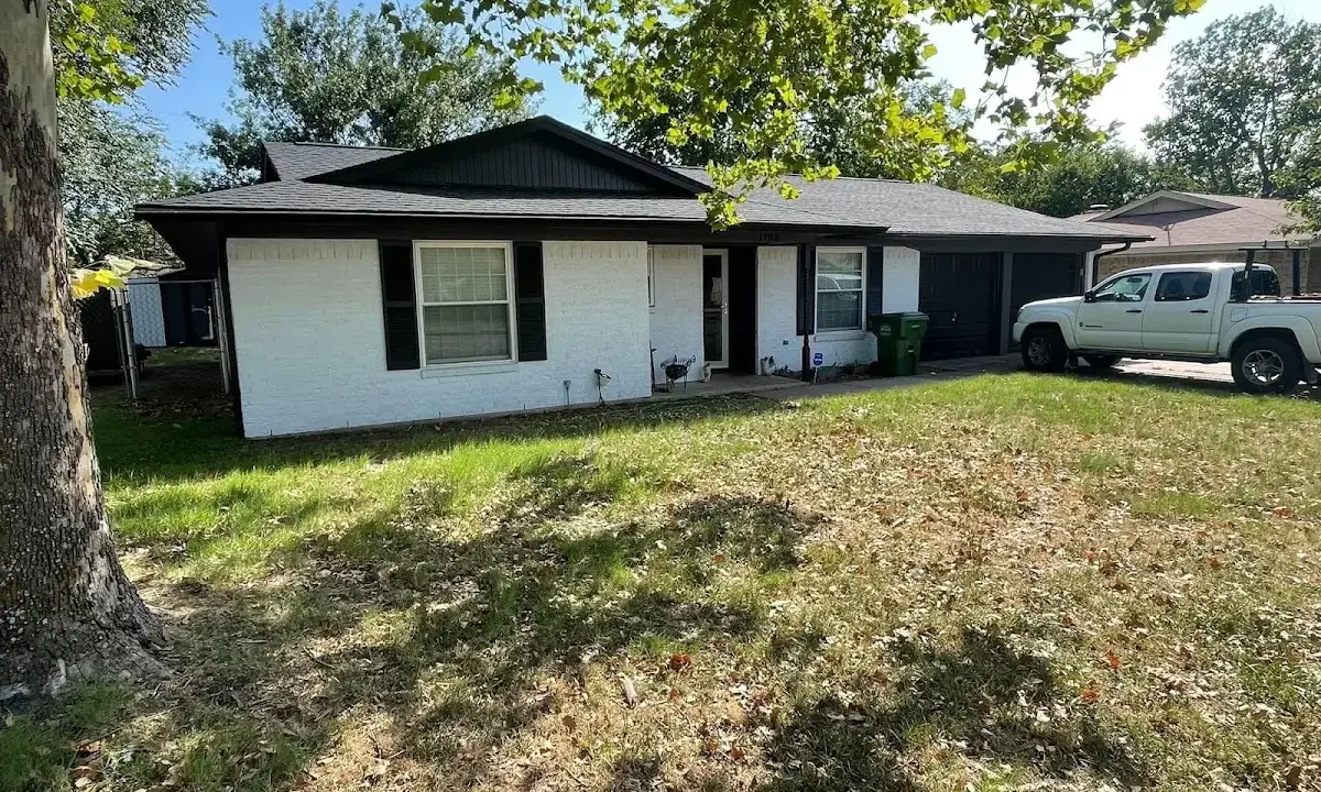 Professional roofing crew working on a residential roof in Fort Riley